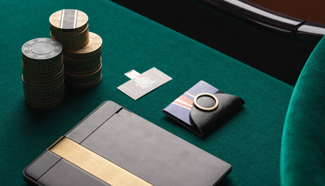 Casino chips and a sealed bonus voucher beside a closed laptop